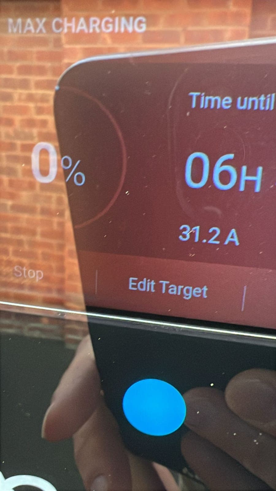 Completed Ohme EV charger installation on external brick wall