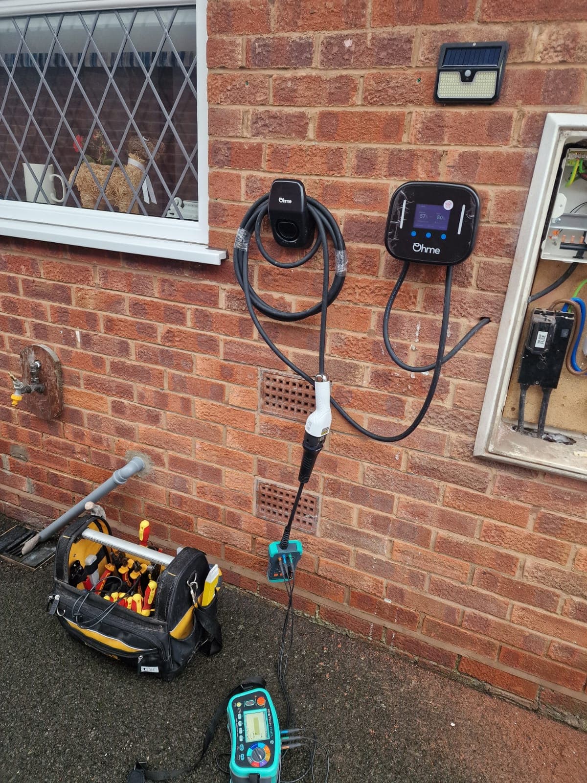 External meter box with consumer unit and new EV charger circuit being installed