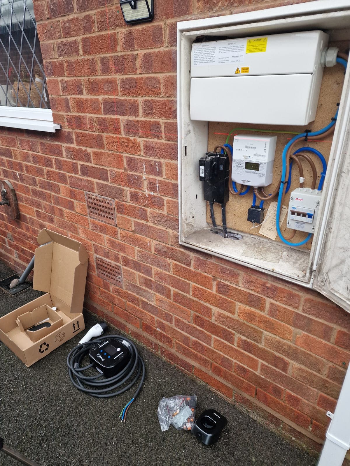 EV charger, cable and fixings laid out ready for installation