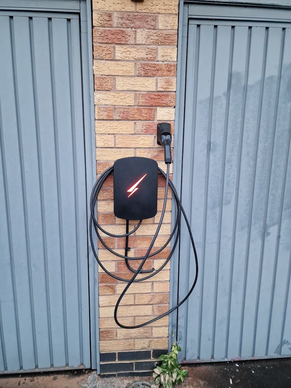 Hypervolt charger installed on brick wall with cable