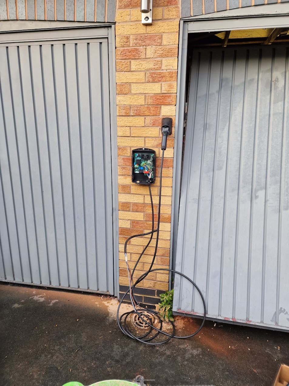Hypervolt charger installation location on brick wall near garage