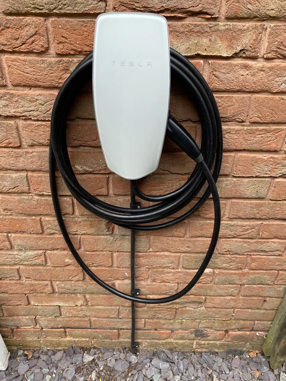 Tesla Wall Connector installed neatly on an exterior wall