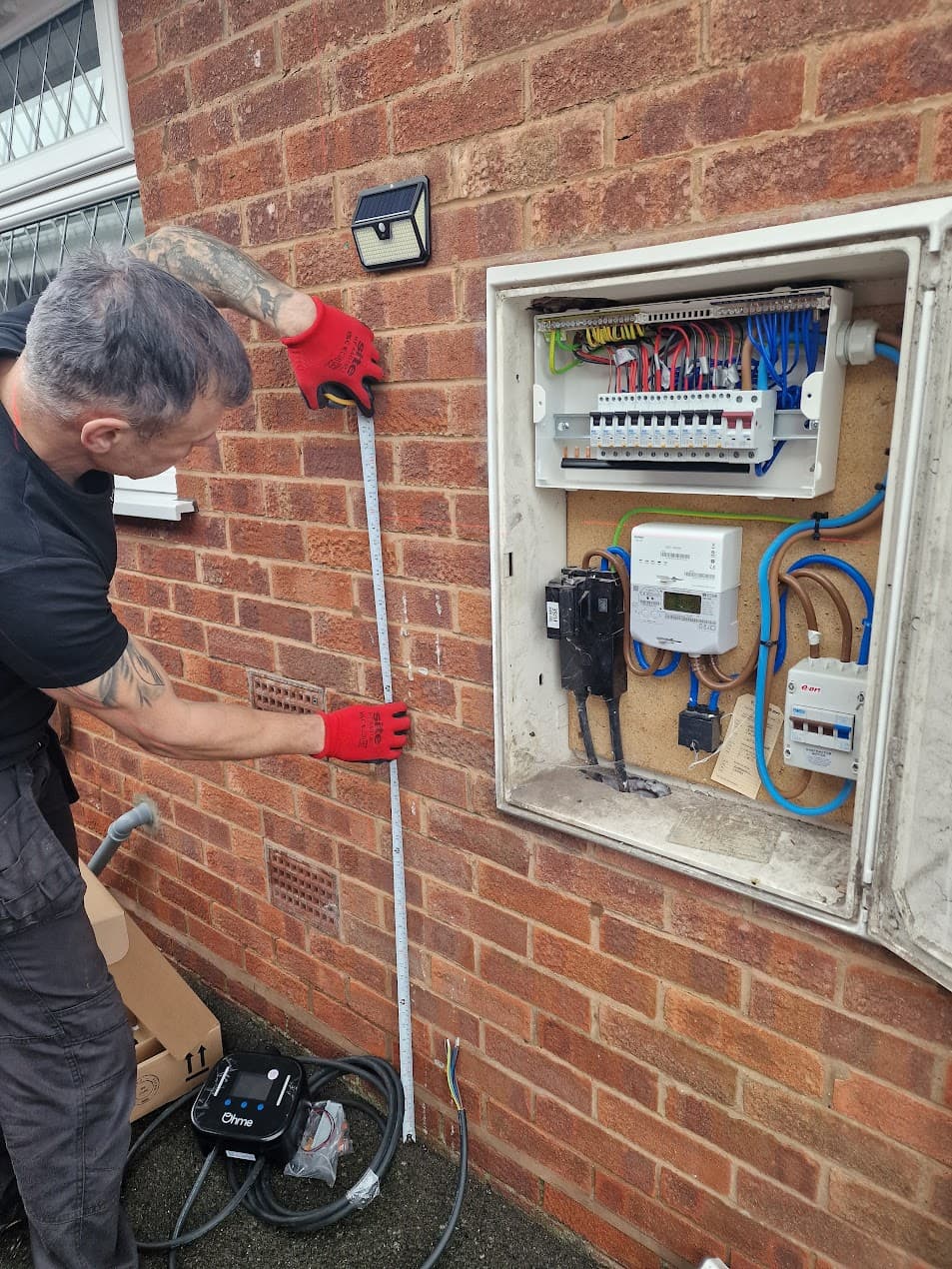 Close-up of Ohme Home Pro installation with tidy cable management