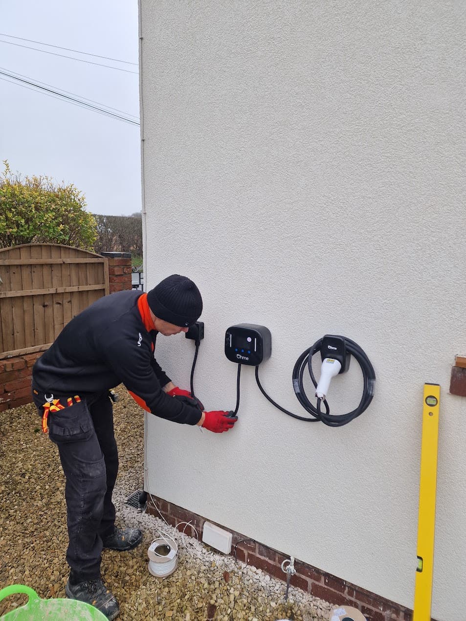 Ohme Home Pro EV charger installed on an exterior wall